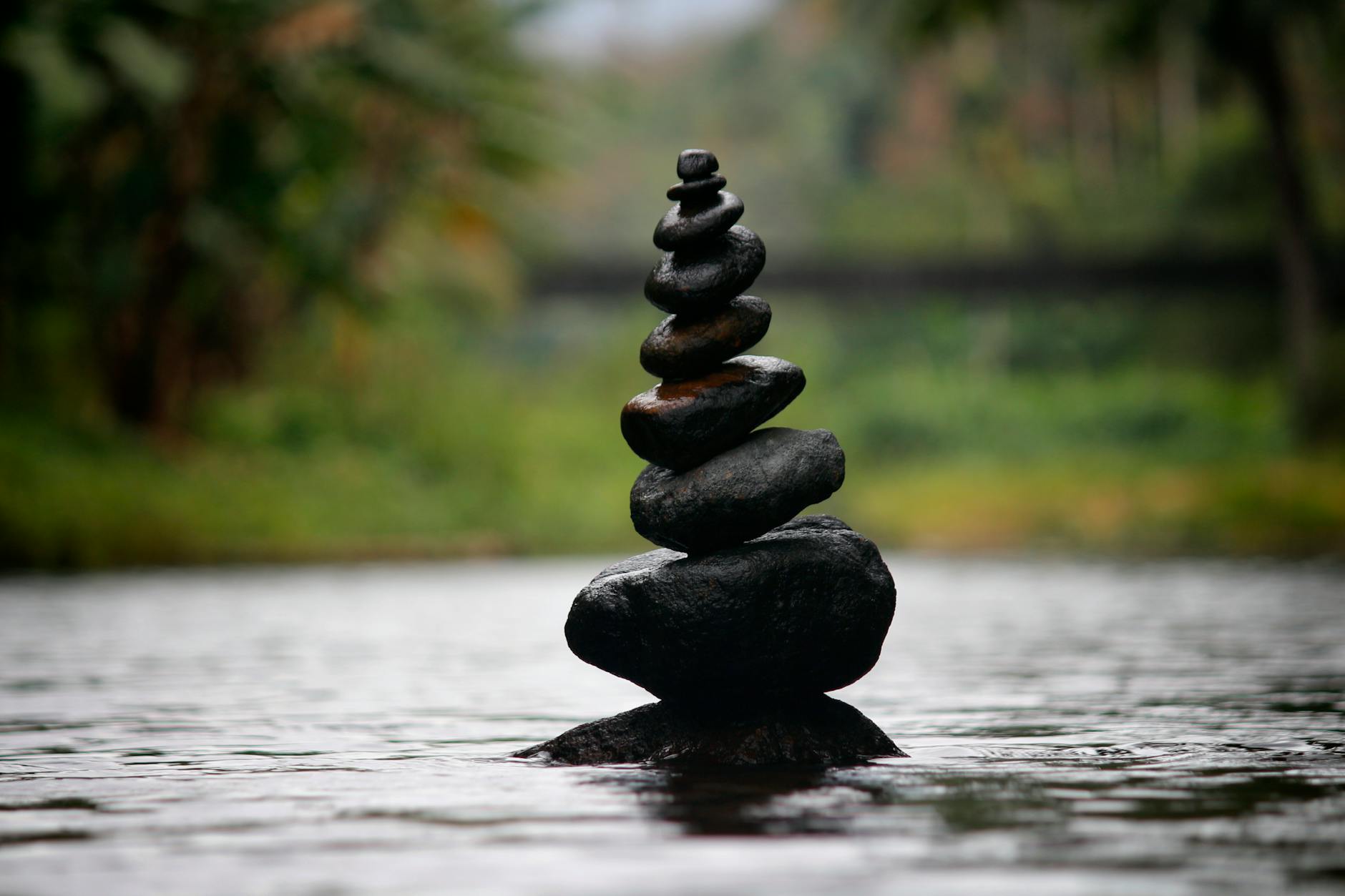 black stackable stone decor at the body of water